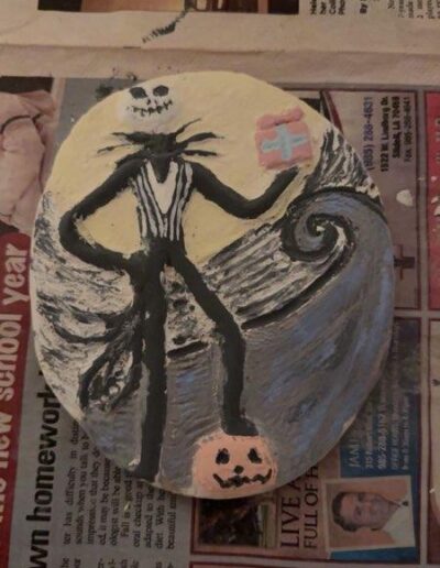 a painted rock with a cartoon character on it