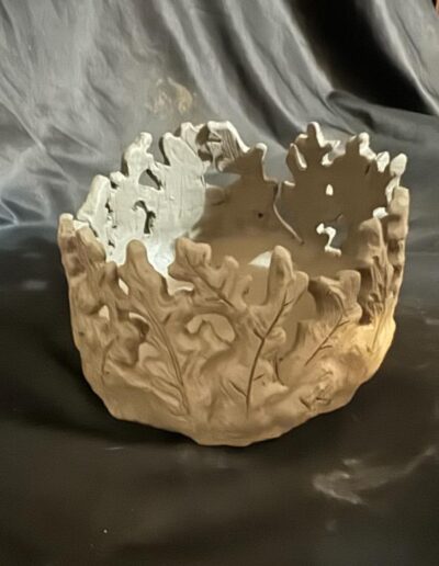 a white bowl with leaves on it